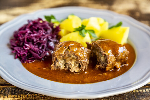 Beef roulade with potato and red cabbage on plate stock photo