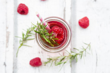 Glass bottle of homemade raspberry lemonade flavoured with rosemary - LVF06974