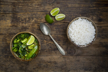 Green thai curry with broccoli, pak choi, snow peas, baby spinach, lime and bowl of rice - LVF06975