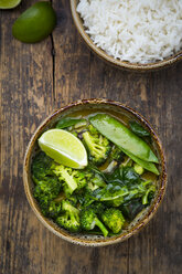 Green thai curry with broccoli, pak choi, snow peas, baby spinach, lime and bowl of rice - LVF06978