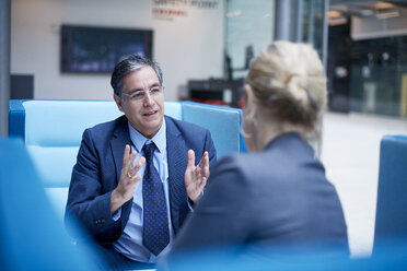 Businesswoman and man at meeting in office - CUF06545