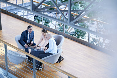 High angle view of businessmen and businesswoman meeting on office balcony - CUF06552