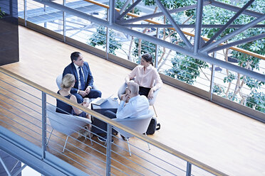 High angle view of businessmen and businesswomen meeting on office balcony - CUF06553