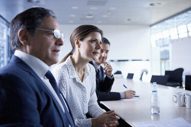 Businesswoman and men listening at office meeting - CUF06613