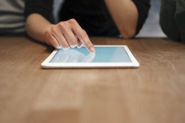 Cropped view of woman using digital tablet - CUF06988