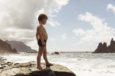 Young boy standing on rock, looking at view, Santa Cruz de Tenerife, Canary Islands, Spain, Europe - CUF07238