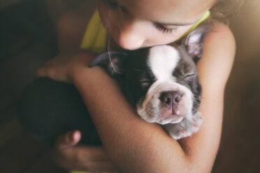 Mädchen umarmt Boston Terrier Welpe - ISF01520