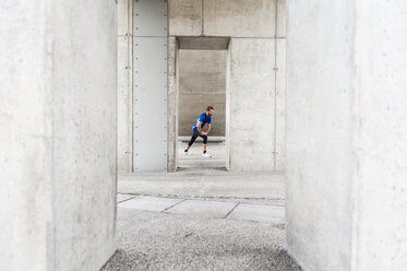 Man stetching at an underpass - DIGF04248