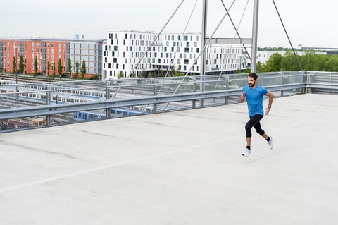 Man running on a parking level stock photo