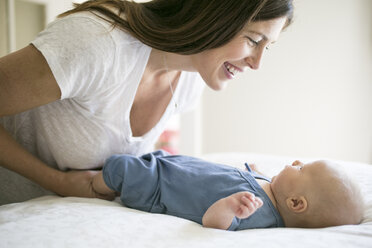 Mother playing with baby boy, face to face, smiling - ISF01616