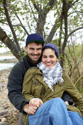 Portrait of happy young couple at beach - ISF01673