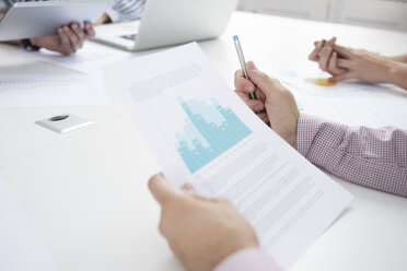 Cropped shot of businesswomen and men with paperwork and digital tablet boardroom table - CUF07817