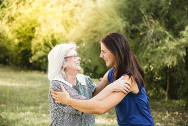 Senior woman, hugging granddaughter, outdoors - CUF07897