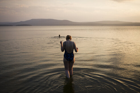 Woman walking in shallow water, Nizny Tagil, Russia - CUF07961