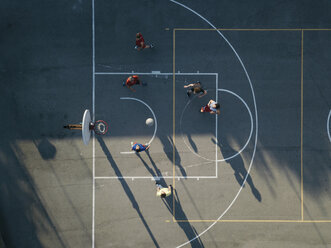 Overhead view of friends on basketball court playing basketball game - CUF07972
