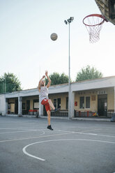 Man jumping for basketball hoop - CUF07977