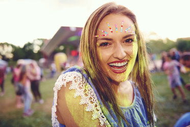 Portrait of young hippy woman in floral headband and sunglasses at festival  stock photo