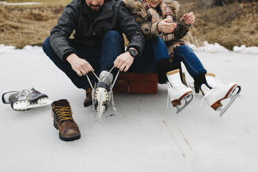 Man tying shoelace on ice skates - ISF01834