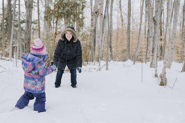 Mother and daughter playing in snow, Peterborough, Ontario - ISF02048