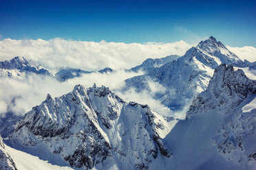 Clouds on snow capped mountain peaks, Engelberg Titlis, Swiss Alps, Switzerland - CUF08106