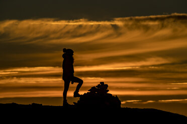 Woman climbing a summit near Tromso in autumn, Arctic Norway - CUF08218