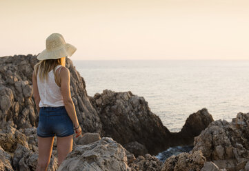 Rear view of woman looking at sea, Ciutadella, Menorca, Spain - CUF08221