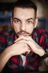 Portrait of tattooed man looking at camera - CUF08305