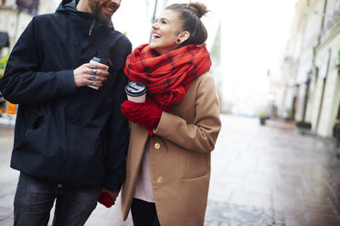 Couple with disposable cups holding hands - CUF08308