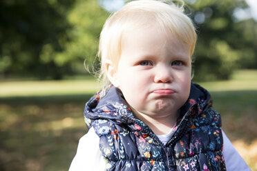 Portrait of female toddler with sulking lip in park - CUF08328