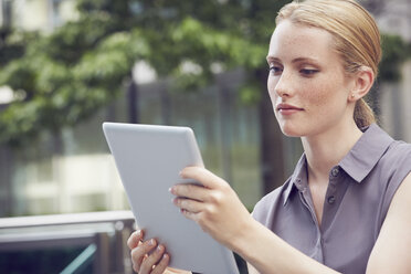 Woman using digital tablet, London, UK - CUF08473