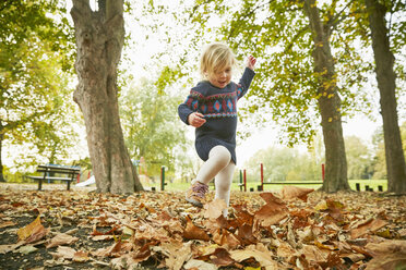 Girl playing in autumn leaves - CUF08505