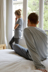 Mid adult couple in bedroom, having disagreement - CUF08572