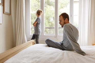 Mid adult couple in bedroom, having disagreement - CUF08573