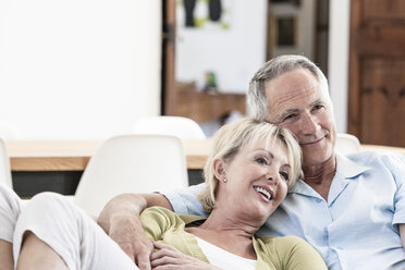 Couple relaxing together on sofa - CUF08876