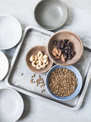 Studio shot, overhead view of cashew nuts, almonds, seeds and dried fruit in bowls - CUF08921