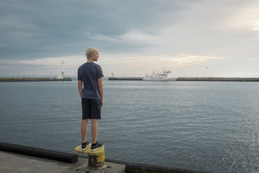 Poland, Gdansk Bay, teenage boy standing on quay looking at distance - HAMF00268