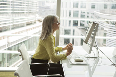 Businesswoman working at computer, London, UK - CUF08963