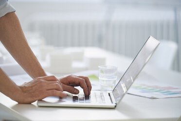 Cropped view of man using laptop - CUF09093