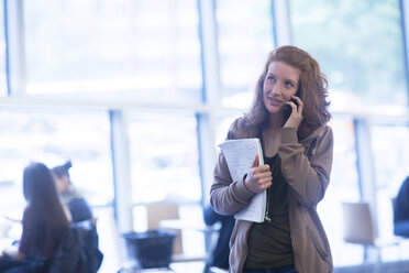 Student using mobile phone in library - CUF09167