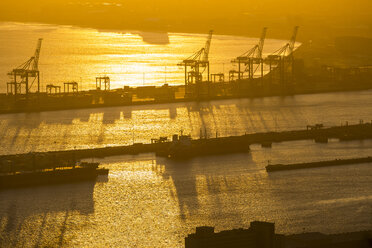 Africa, South Africa, Cape Town, Dockyard with cranes and ships at sunset - ZEF15425