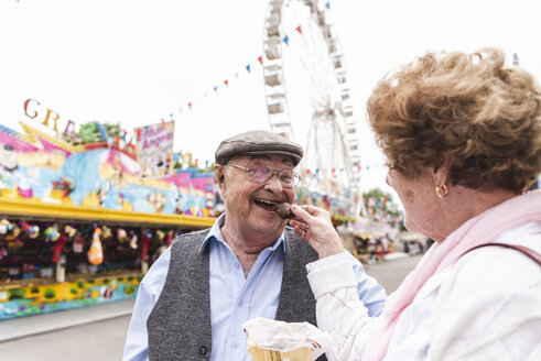 Portrait of happy senior man having fun with his wife on fair - UUF13745