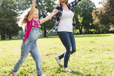 Happy mother with daughter in a park - UUF13768