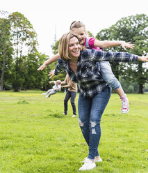 Active happy family in a park - UUF13782