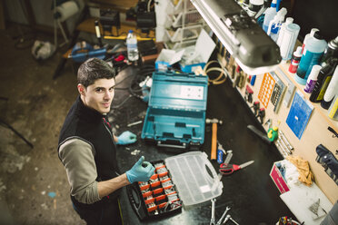 Portrait of a confident mechanic in his workshop - RAEF02039
