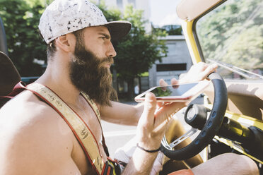 Junger männlicher Hipster auf Road Trip mit Smartphone-Navigation, Como, Lombardei, Italien - CUF09371