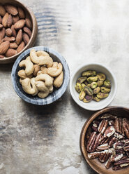 Variety of mixed nuts in bowls, close-up - CUF09420