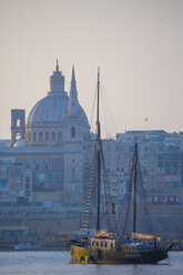 Fishing boat by carmelite church and St Paul's Cathedral, Valletta, Malta - CUF09550