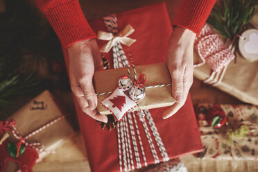 Cropped view of woman holding christmas present - CUF09638