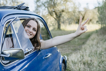 Woman looking out of car window smiling, peace sign, Firenze, Toscana, Italy, Europe - CUF09666