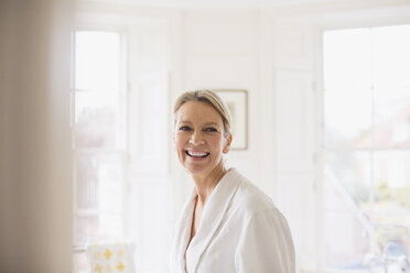 Portrait smiling, confident mature woman in bathrobe - HOXF03594